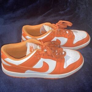Orange and white Nike dunks low top